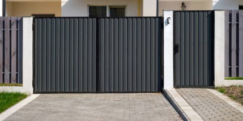 New metal gates and a fence in front of the house.